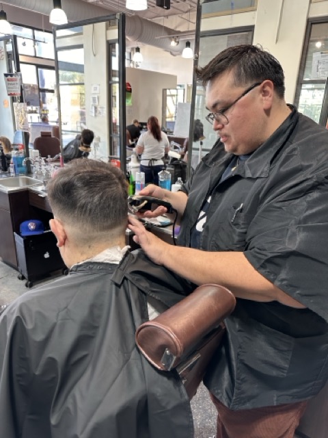Client with a sharp fade and styled top.