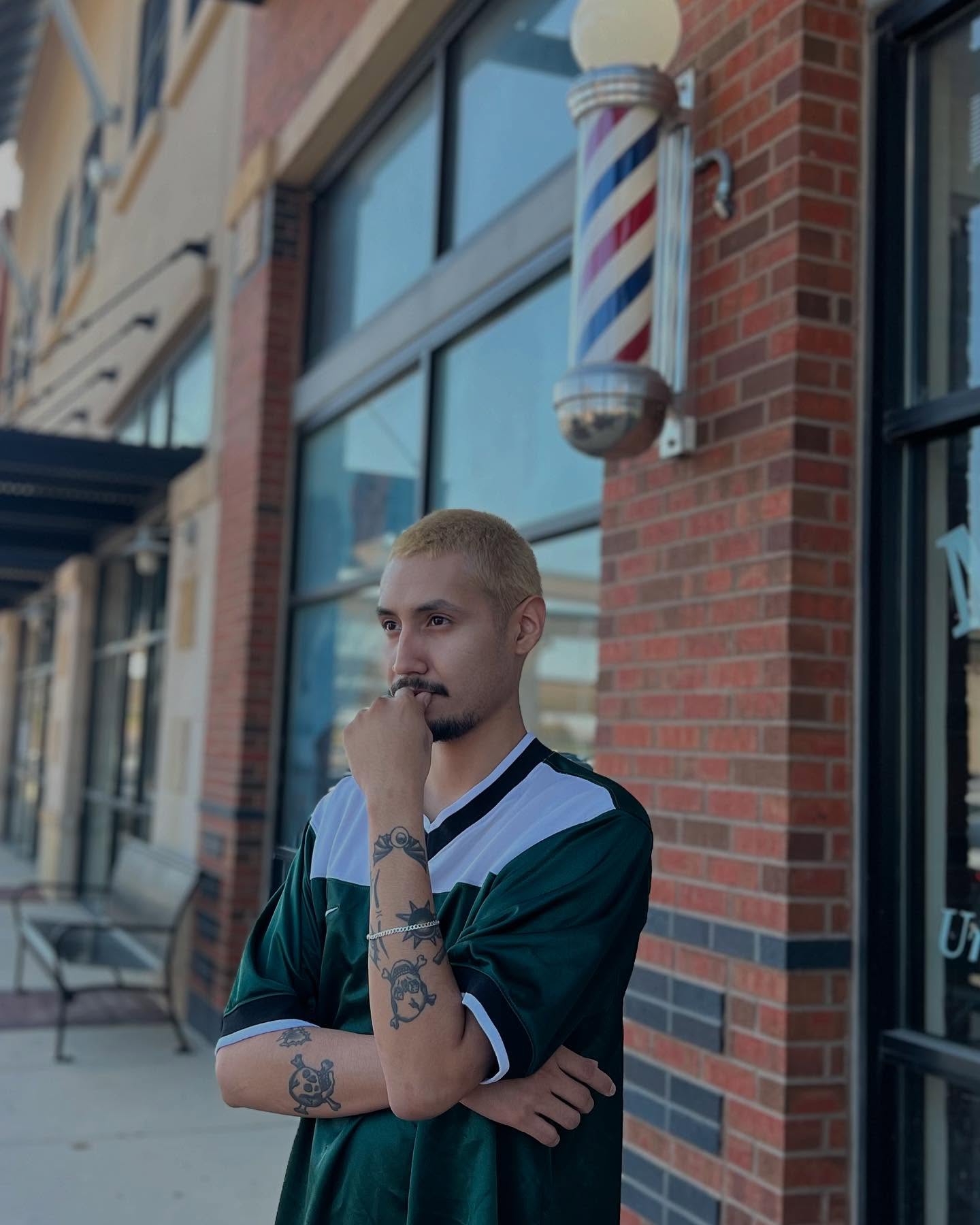 Stoic dude deep in thought with his new bleached hair.